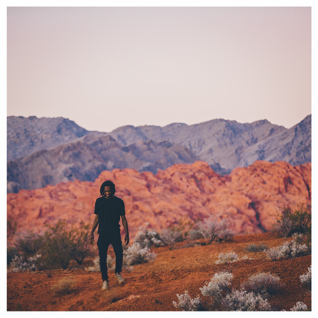 Album Cover: The artist in a mountainous desert landscape